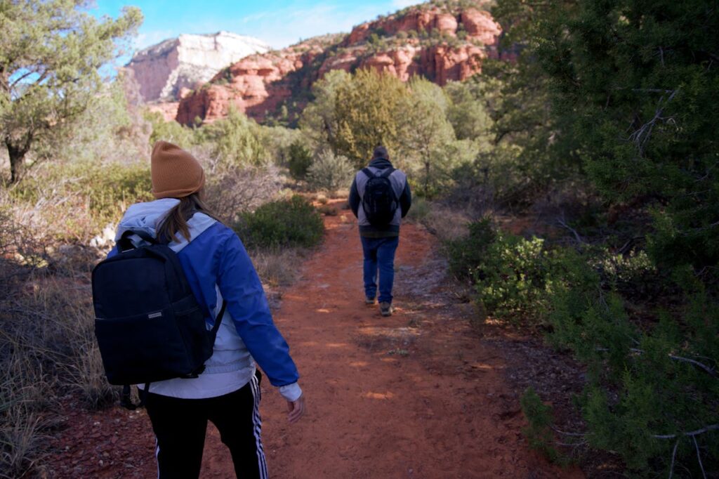 Backpackers explore the stunning red rock trails of Sedona, Arizona.